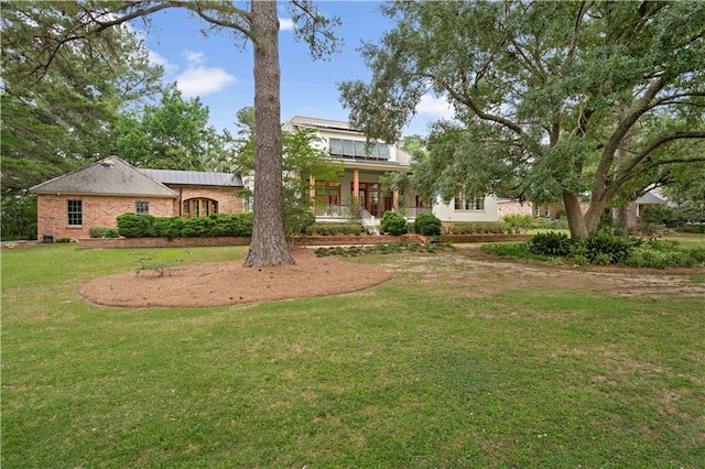 580 Northwoods Dr, Abita Springs, LA 70420 - rear view of house with a yard and brick siding