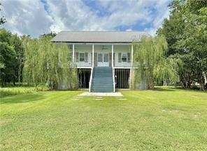 110 Mulberry Ave, Mandeville, LA 70448 - rear view of house featuring a lawn