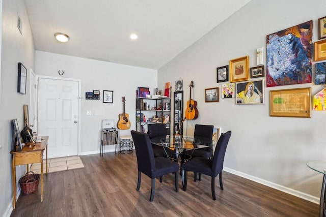 350 Emerald Forest Blvd Unit 11202, Covington, LA 70433 - dining area with dark wood-style flooring, vaulted ceiling, and baseboards
