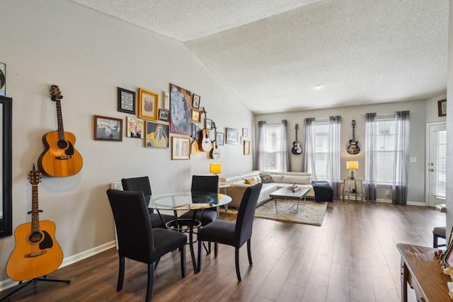350 Emerald Forest Blvd Unit 11202, Covington, LA 70433 - dining room featuring dark wood-style flooring, a textured ceiling, plenty of natural light, lofted ceiling, and baseboards