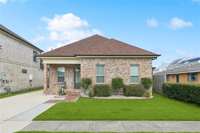 1516 Huron Ave, Metairie, LA 70005 - view of front of house with brick siding, a front yard, roof with shingles, and a porch