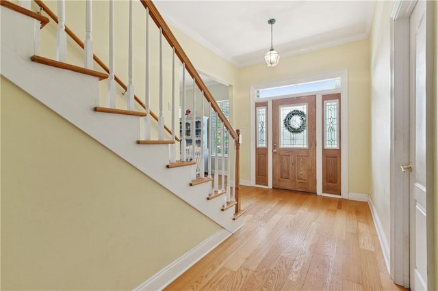 6661 Colbert St, New Orleans, LA 70124 - foyer with wood finished floors, stairway, and crown molding