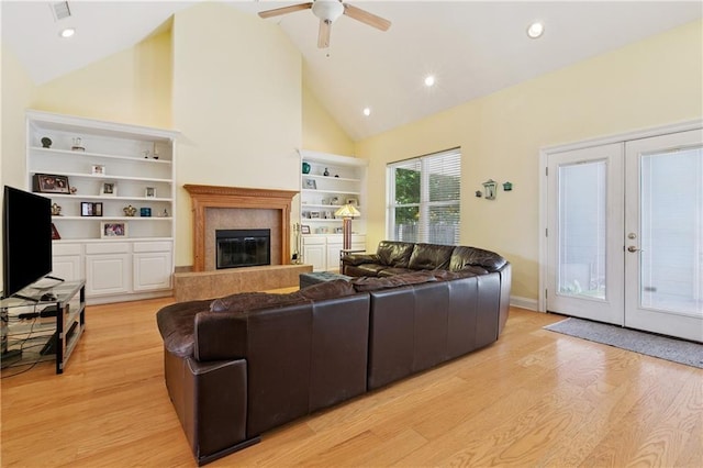 6661 Colbert St, New Orleans, LA 70124 - living room with light wood-style floors, ceiling fan, high vaulted ceiling, a high end fireplace, and french doors