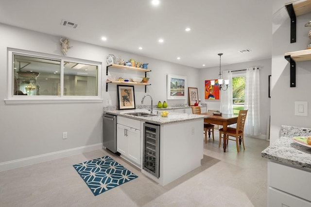 1012 W 11th Ave, Covington, LA 70433 - kitchen featuring a sink, beverage cooler, stainless steel dishwasher, white cabinetry, and recessed lighting
