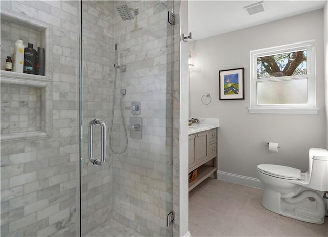 1012 W 11th Ave, Covington, LA 70433 - full bathroom featuring vanity, toilet, a shower stall, tile patterned floors, and baseboards