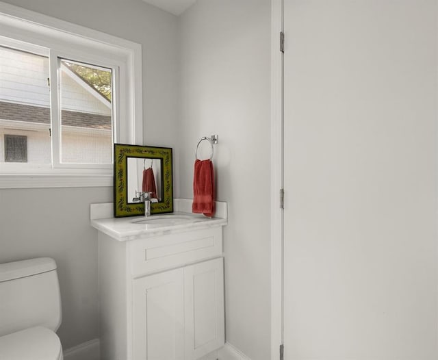 1012 W 11th Ave, Covington, LA 70433 - bathroom with toilet, baseboards, and vanity