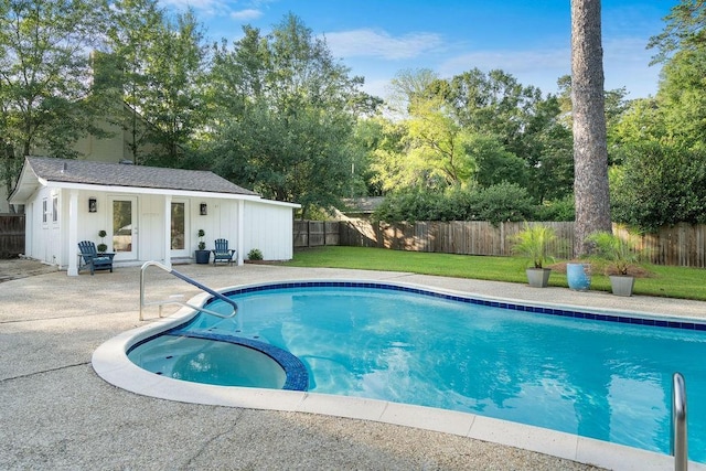 1012 W 11th Ave, Covington, LA 70433 - view of pool with a patio, an outbuilding, an exterior structure, a pool with connected hot tub, and view of wooded area