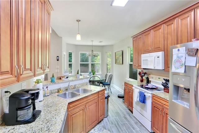 28628 Violet St, Lacombe, LA 70445 - kitchen featuring white appliances, a sink, hanging light fixtures, baseboards, and brown cabinets