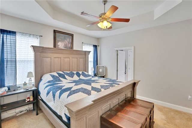28628 Violet St, Lacombe, LA 70445 - bedroom with light colored carpet, a tray ceiling, baseboards, and a ceiling fan
