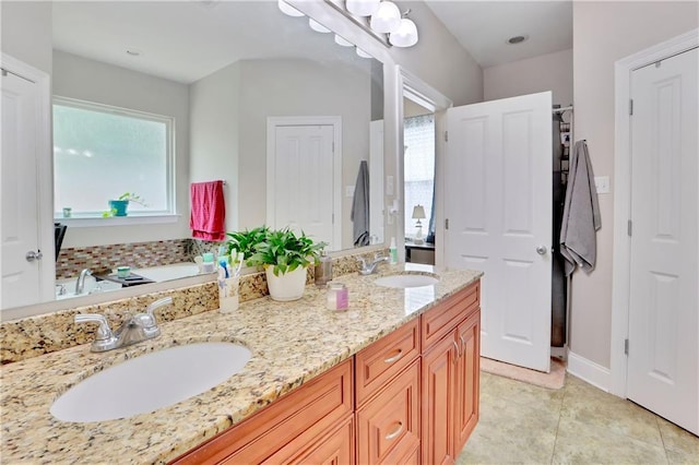 28628 Violet St, Lacombe, LA 70445 - full bathroom featuring double vanity, tile patterned floors, a tub to relax in, and baseboards