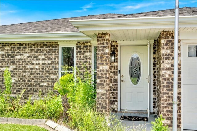 3140 Arbutus Ln, Marrero, LA 70072 - entrance to property featuring a shingled roof and brick siding