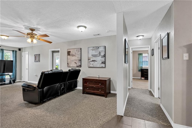 3140 Arbutus Ln, Marrero, LA 70072 - carpeted living area featuring ceiling fan, a textured ceiling, and baseboards