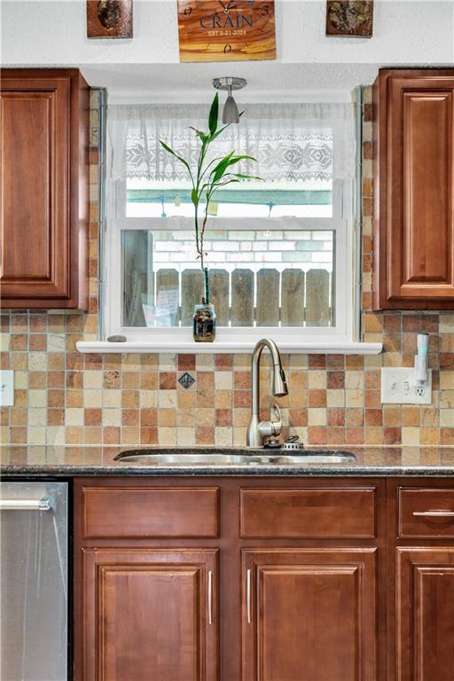 3140 Arbutus Ln, Marrero, LA 70072 - kitchen with a sink, backsplash, and brown cabinets