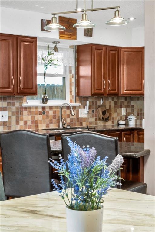 3140 Arbutus Ln, Marrero, LA 70072 - kitchen with decorative backsplash, a sink, and pendant lighting