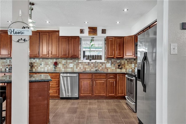 3140 Arbutus Ln, Marrero, LA 70072 - kitchen with stainless steel appliances, a sink, brown cabinets, decorative backsplash, and a textured ceiling