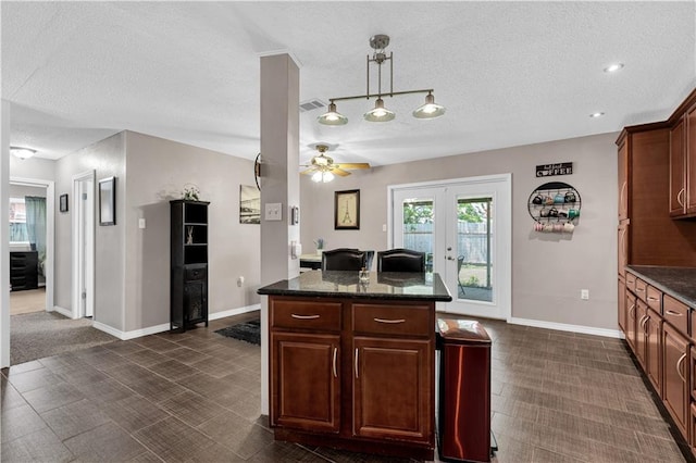 3140 Arbutus Ln, Marrero, LA 70072 - kitchen featuring a ceiling fan, a textured ceiling, baseboards, pendant lighting, and french doors