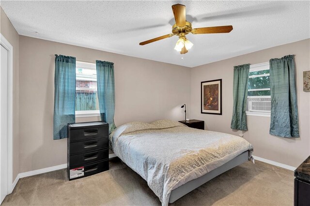 3140 Arbutus Ln, Marrero, LA 70072 - bedroom featuring multiple windows, light carpet, baseboards, and a textured ceiling