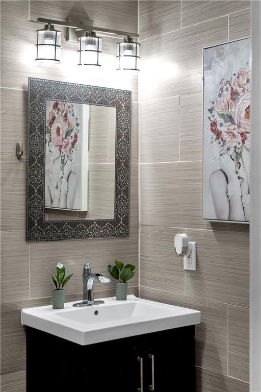 3140 Arbutus Ln, Marrero, LA 70072 - bathroom featuring vanity and tile walls