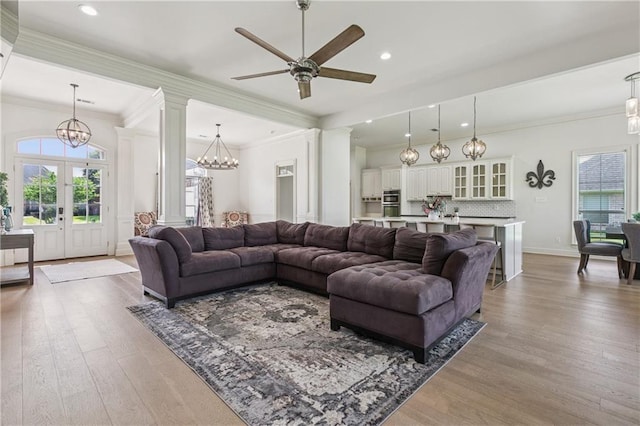 108 Parkview Dr, La Place, LA 70068 - living area featuring a chandelier, ornamental molding, plenty of natural light, light wood-style floors, and ceiling fan