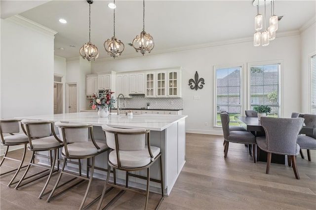 108 Parkview Dr, La Place, LA 70068 - kitchen with a chandelier, ornamental molding, backsplash, wood finished floors, and hanging light fixtures