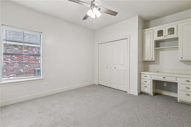 108 Parkview Dr, La Place, LA 70068 - unfurnished office with light colored carpet, ceiling fan, baseboards, and built in desk
