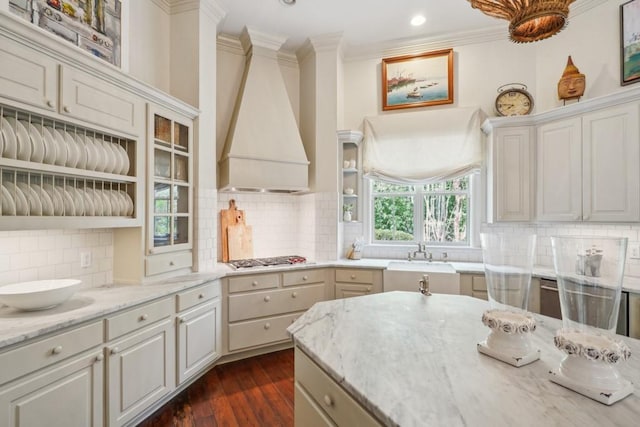 20 Beechwood Gardens Ln, Covington, LA 70435 - kitchen featuring custom exhaust hood, a sink, crown molding, light stone countertops, and dark wood-style floors
