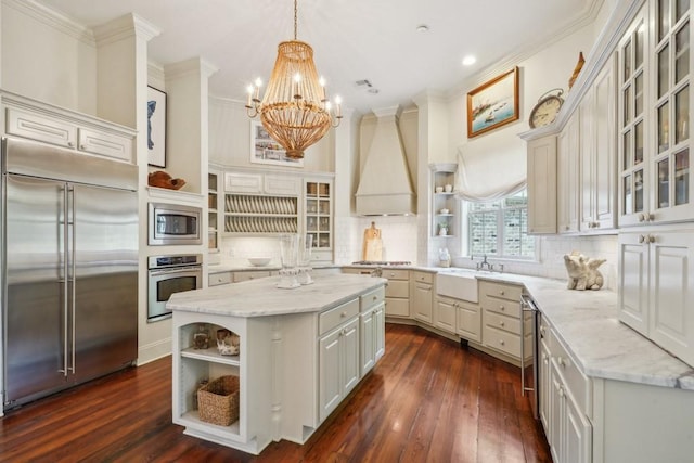 20 Beechwood Gardens Ln, Covington, LA 70435 - kitchen featuring built in appliances, open shelves, a sink, a chandelier, and a center island