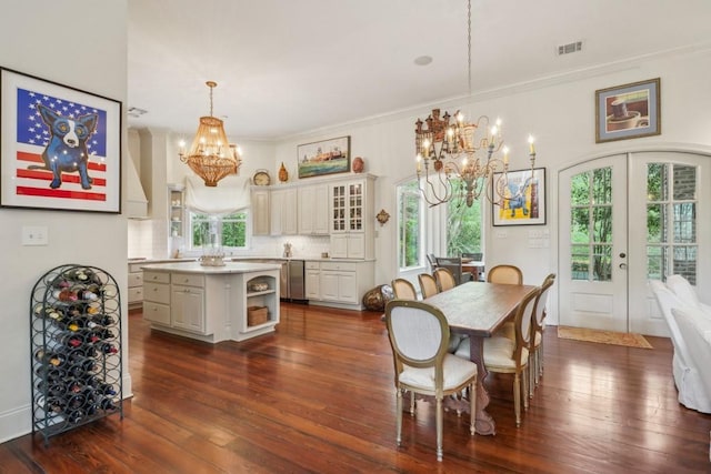 20 Beechwood Gardens Ln, Covington, LA 70435 - dining room with a chandelier, french doors, healthy amount of natural light, dark wood-type flooring, and ornamental molding