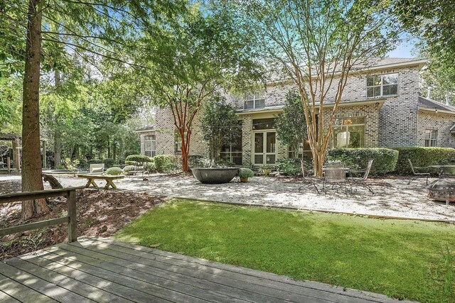 20 Beechwood Gardens Ln, Covington, LA 70435 - view of green lawn with a patio area, a deck, and an outdoor fire pit