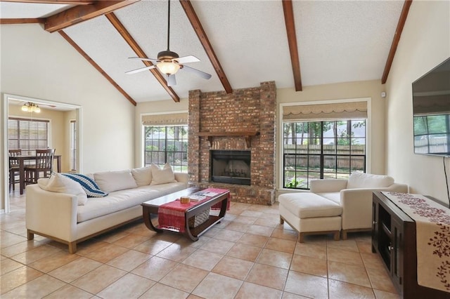 111 Thatcher Dr, Slidell, LA 70461 - living room featuring a ceiling fan, light tile patterned floors, beamed ceiling, a fireplace, and high vaulted ceiling