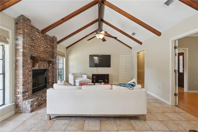 111 Thatcher Dr, Slidell, LA 70461 - living room with healthy amount of natural light, a fireplace, a ceiling fan, and light tile patterned floors