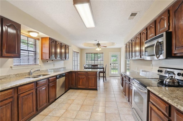 111 Thatcher Dr, Slidell, LA 70461 - kitchen with stainless steel appliances, a sink, ceiling fan, healthy amount of natural light, and a textured ceiling