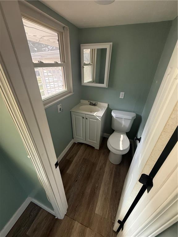 245 W Tish Dr, Avondale, LA 70094 - half bath featuring wood finished floors, toilet, vanity, and baseboards