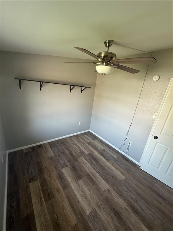 245 W Tish Dr, Avondale, LA 70094 - empty room featuring dark wood-type flooring, a ceiling fan, baseboards, and a smoke detector