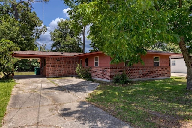 472 Cumberland Dr, Slidell, LA 70458 - ranch-style house featuring an attached carport, a front lawn, concrete driveway, and brick siding