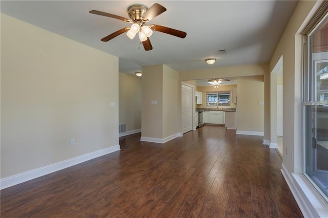 472 Cumberland Dr, Slidell, LA 70458 - unfurnished living room featuring a ceiling fan, dark wood finished floors, and baseboards