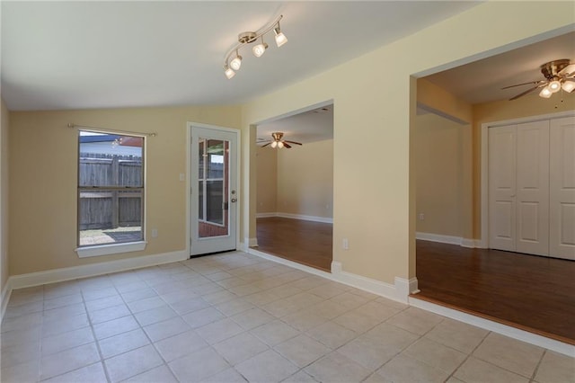 472 Cumberland Dr, Slidell, LA 70458 - empty room with ceiling fan, light tile patterned floors, baseboards, and vaulted ceiling