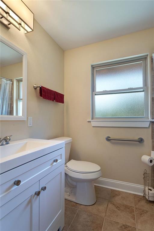 472 Cumberland Dr, Slidell, LA 70458 - bathroom with toilet, vanity, tile patterned floors, and baseboards