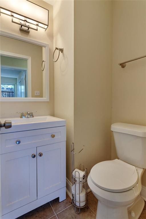 472 Cumberland Dr, Slidell, LA 70458 - bathroom with toilet, vanity, tile patterned floors, and baseboards