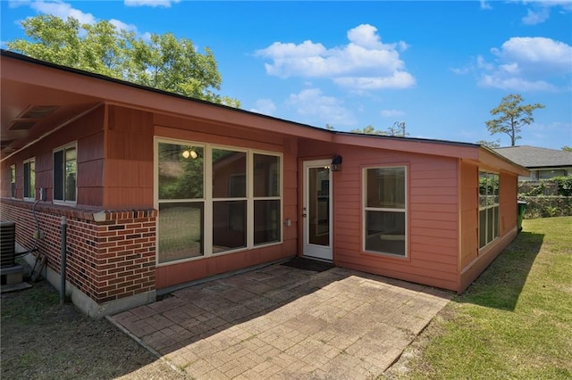 472 Cumberland Dr, Slidell, LA 70458 - back of property featuring a patio, a lawn, and central AC