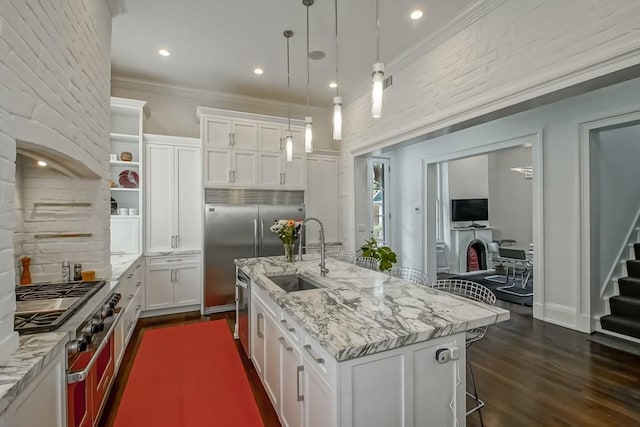 1456 Camp St, New Orleans, LA 70130 - kitchen featuring a sink, dark wood-style flooring, white cabinets, an island with sink, and ornamental molding