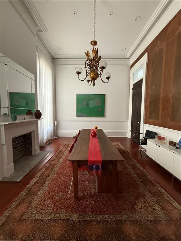 1456 Camp St, New Orleans, LA 70130 - dining room featuring a chandelier, wood finished floors, ornamental molding, and baseboards