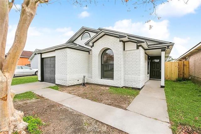 1938 W Homestead Dr, New Orleans, LA 70114 - view of front of home with brick siding, a garage, and concrete driveway