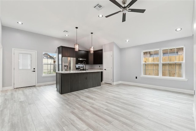 1938 W Homestead Dr, New Orleans, LA 70114 - kitchen with stainless steel fridge, light countertops, a ceiling fan, baseboards, and light wood-type flooring