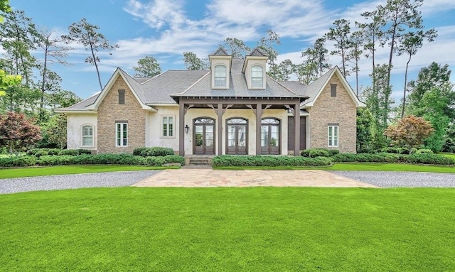 26 Hummingbird Rd, Covington, LA 70433 - view of front of house with a front yard, stucco siding, french doors, and stone siding