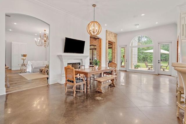 26 Hummingbird Rd, Covington, LA 70433 - dining room with a chandelier, crown molding, recessed lighting, a fireplace, and arched walkways