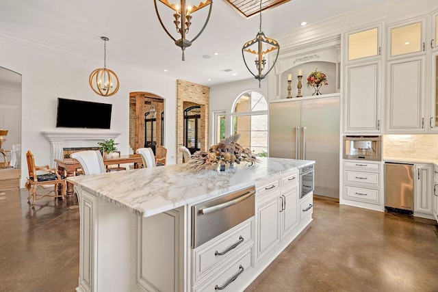 26 Hummingbird Rd, Covington, LA 70433 - kitchen with finished concrete floors, a warming drawer, arched walkways, light stone counters, and ornamental molding