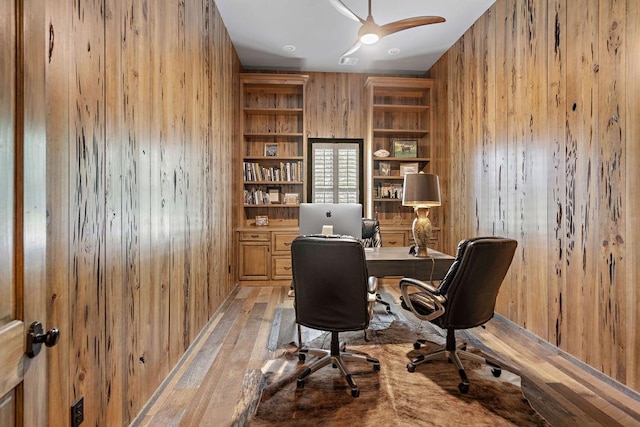 26 Hummingbird Rd, Covington, LA 70433 - office featuring wood walls, light wood-style floors, built in shelves, and ceiling fan