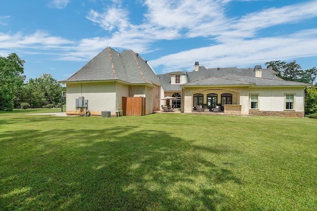 26 Hummingbird Rd, Covington, LA 70433 - rear view of property with stucco siding, a yard, and central AC
