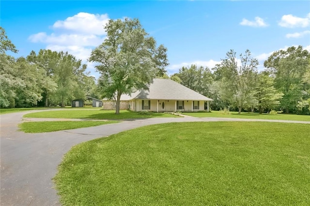 37112 Harper Ln, Pearl River, LA 70452 - surrounding community featuring curved driveway, a yard, and view of wooded area
